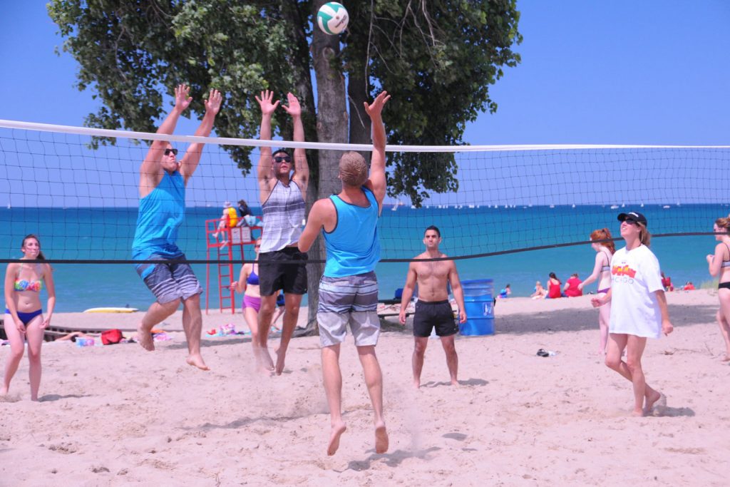 Bunch of youth playing beach volleyball