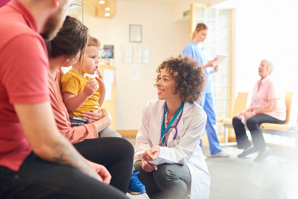 Doctor talks with family with child