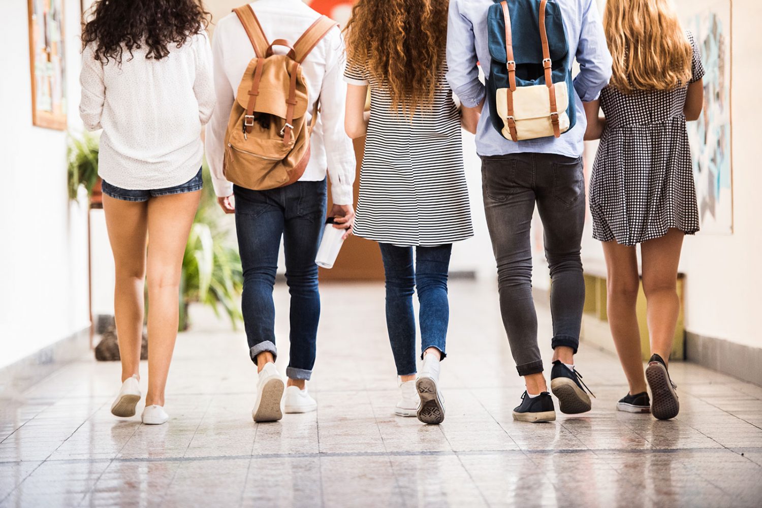 Young students walking down school hall