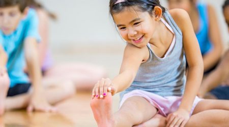 Children stretch at exercise class