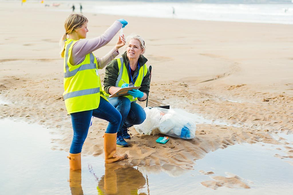 Two inspectors examine beach water sample.