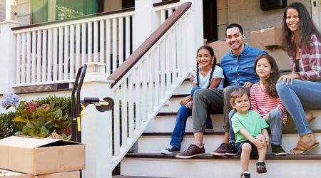 Family sits on porch steps