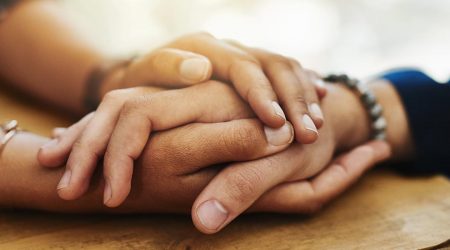 Two people holding hands dealing with emergency