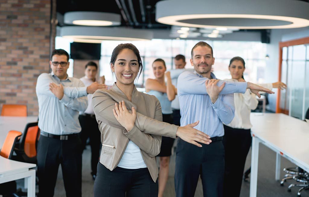 Group of office workers doing stretches