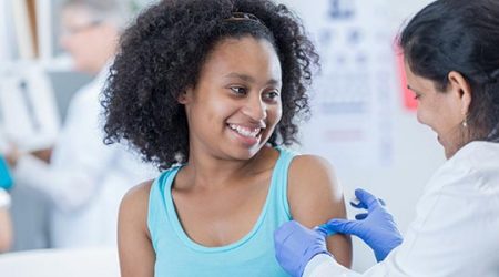 Young girl gets immunized.
