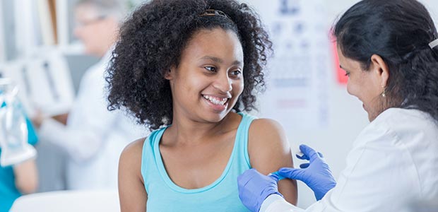 Young girl gets immunized.