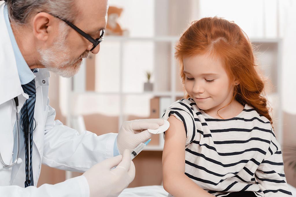 Doctor gives young girl a vaccination