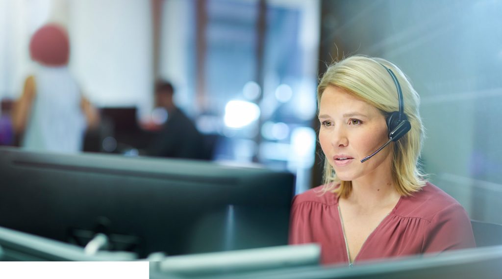 A woman answering a call at a call centre.