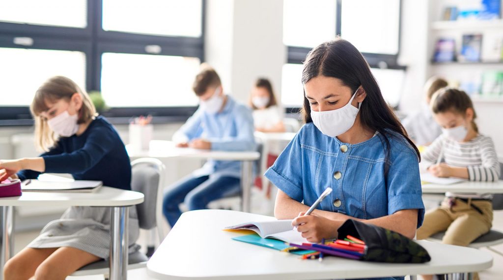 Students wearing masks in a classroom.