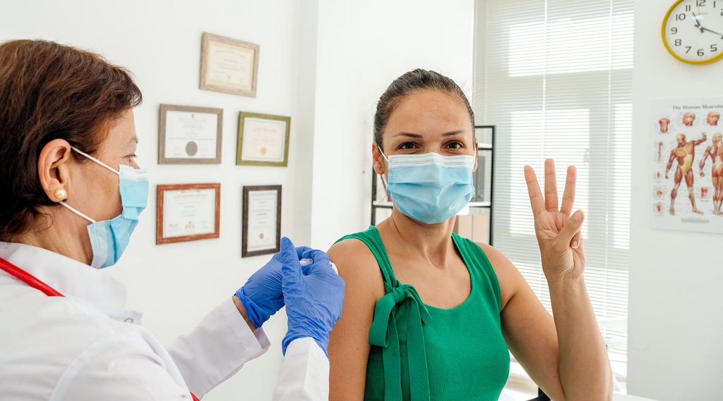 A woman receiving her third dose of the COVID-19 vaccine.