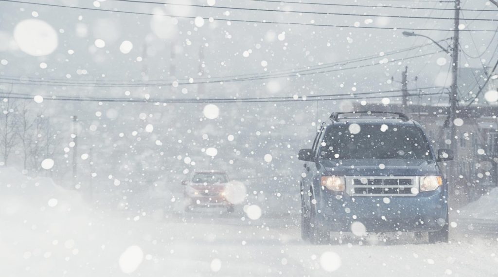 Vehicles driving in a storm storm.