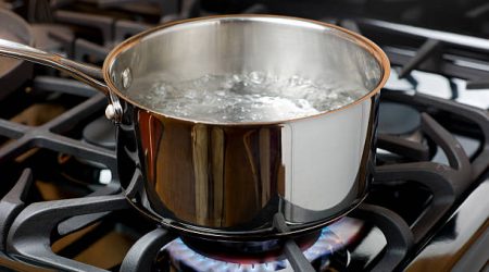 A pot of boiling water on the stove.