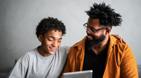 Father and son enjoying time on the tablet